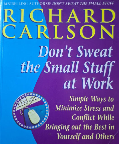 Book titled 'Don't Sweat the Small Stuff at Work' by Richard Carlson on a wooden surface